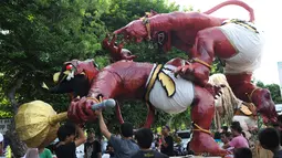 Umat Hindu Bali menyiapkan Ogoh-Ogoh sebelum parade hari Nyepi di Denpasar, Bali, Senin (27/3). Umat Hindu di Bali akan merayakan hari raya Nyepi Tahun Baru Saka 1939 pada tanggal 28 Maret 2017. (AFP Photo / Sonny Tumbelaka) 