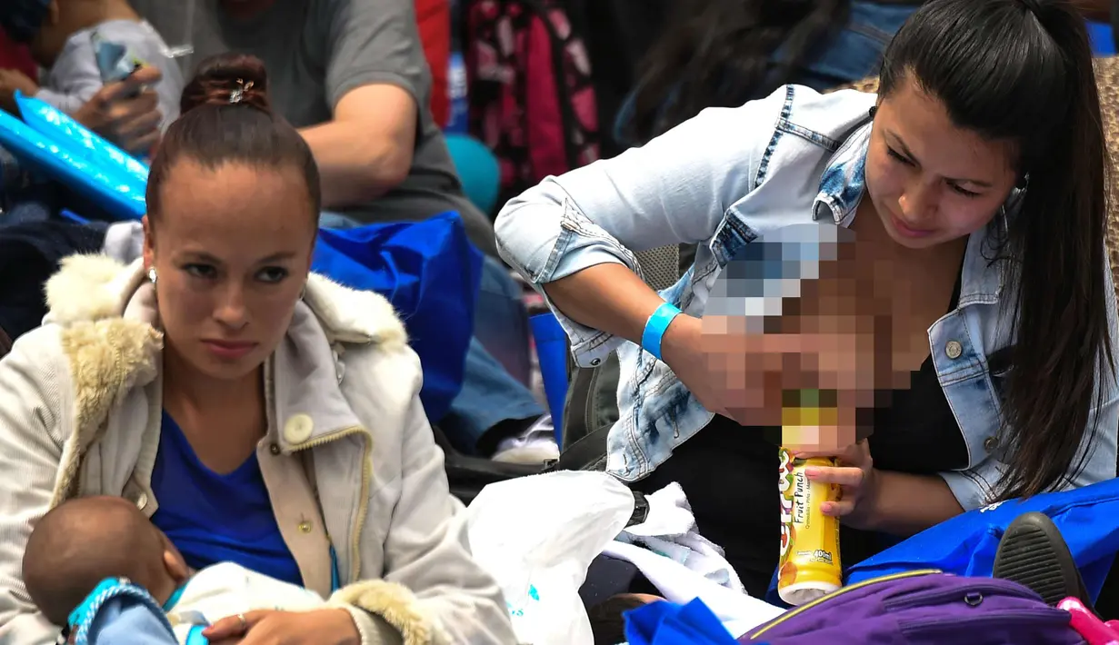 Seorang wanita menyusui bayinya saat mengikuti acara promosi manfaat menyusui, di sebuah taman di Bogota, Kolombia(3/11). Ratusan ibu menyusui bayi mereka untuk mempromosikan pemberian ASI sebagai bagian dari hak bayi. (AFP Photo/Raul Arboleda)