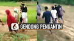 Perjuangan dilakukan oleh warga setempat ketika harus bersusah payah menggendong pengantin pria melewati jalan berlumpur menuju ke rumah pengantin wanita.