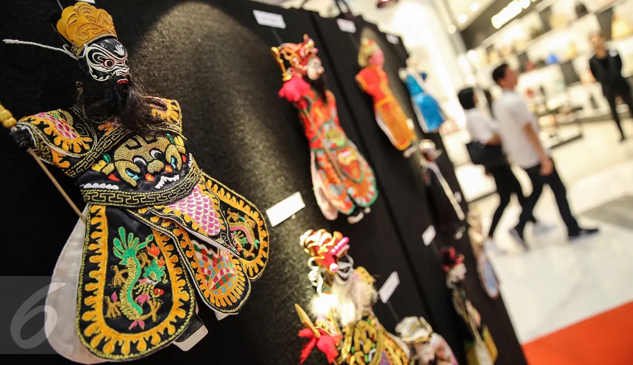 Pengunjung melintas di etalase pameran wayang potehi di Lippo Mall Puri, Jakarta Barat, (21/01). Pameran yang berlangsung hingga 5 Februari ini menjadi daya tarik pengunjung. (Liputan6.com/Fery Pradolo)