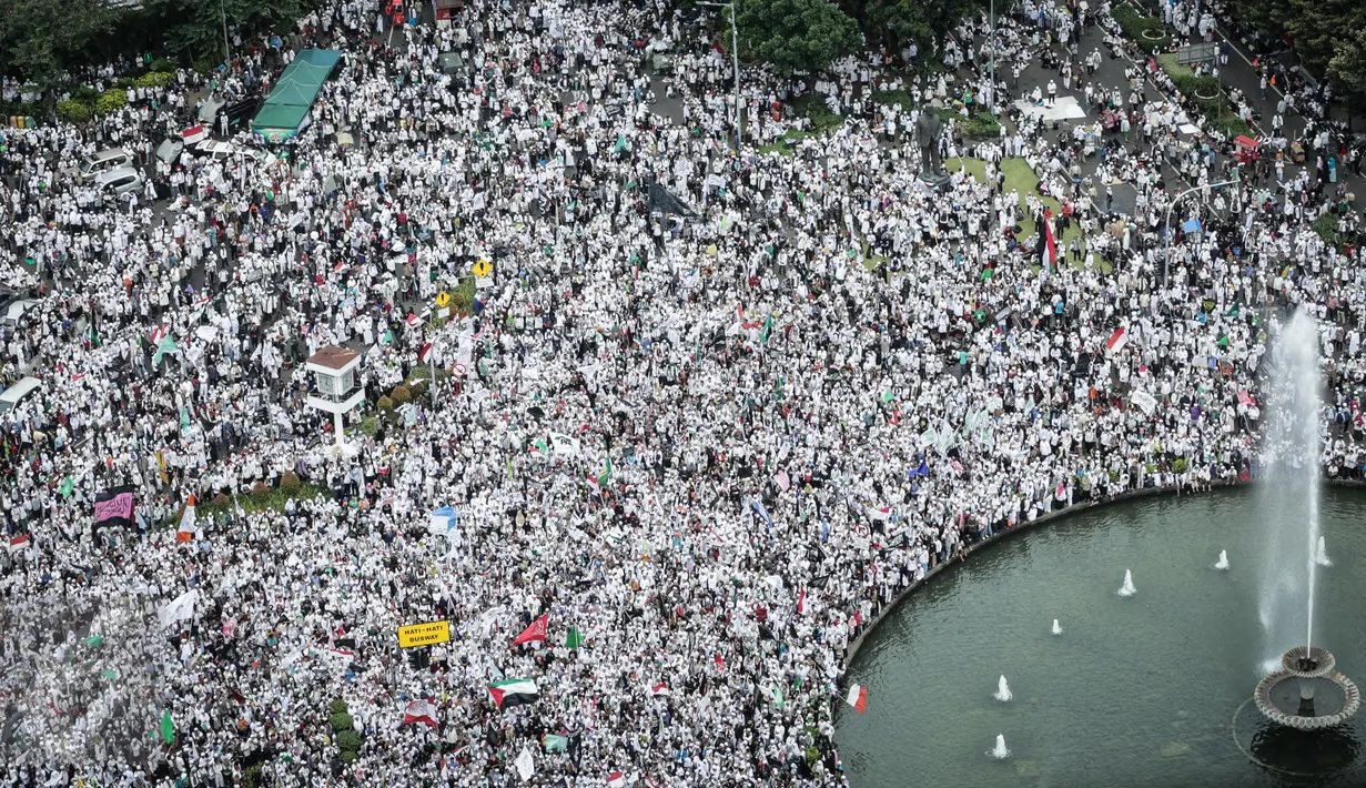 Massa Aksi 31 Maret berkumpul di Bundaran Patung Kuda, Jakarta, Jumat (31/3). Peserta aksi tidak bisa mendekat ke Istana Kepresidenan karena polisi memasang pagar kawat berduri di Jalan Medan Merdeka Barat. (Liputan6.com/Faizal Fanani)