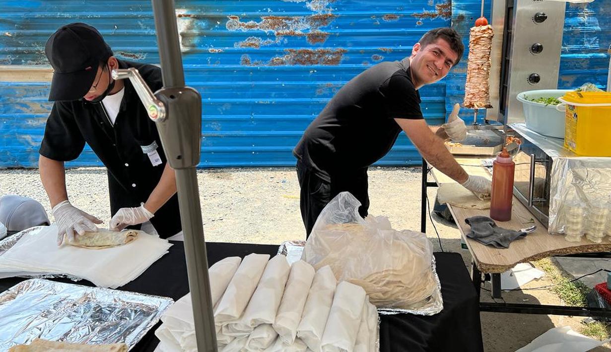 Pedagang kebab Turki di Islamic Center Phnom Penh, Serdar (kanan), sedang mempersiapkan dagangannya sebelum Salat Jumat di Masjid Al Serkal dimulai. (Bola.com/Gregah Nurikhsani)