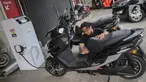Pengunjung melakukan pengisian energi pada sepeda motor listrik di Jakarta, Jumat (12/1/2024). (Liputan6.com/Angga Yuniar)