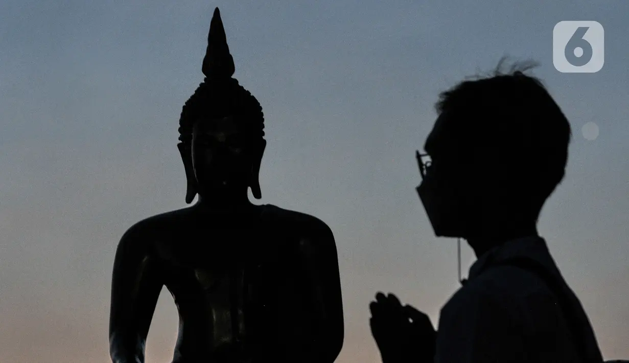 Umat Buddha sembahyang saat mengikuti peringatan Tri Suci Waisak 2565 BE di Vihara Hemadhiro Mettavati, Cengkareng, Jakarta Barat, Rabu (26/5/2021). Peringatan Waisak di wihara ini dimulai dengan sembahyang, kemudian menyiramkan air pada patung Buddha, memberikan koin pada 108 patung Buddha. (merdek