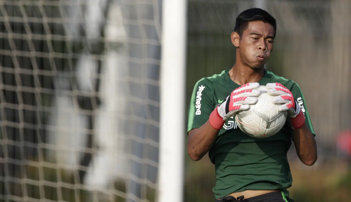 Kiper Timnas Indonesia U-22, Satria Tama, menangkap bola saat latihan di Lapangan ABC Senayan, Jakarta, Kamis (14/2). Latihan ini merupakan persiapan terakhir jelang Piala AFF U-22 2019 di Kamboja. (Bola.com/M. Iqbal Ichsan)