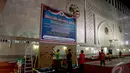 Para pekerja saat menyiapkan baliho bertuliskan tentang informasi yang dipasang di ruang utama Masjid Istiqlal, Jakarta, (4/10/14). (Liputan6.com/Faizal Fanani) 