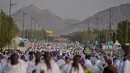 Umat Muslim berjalan menuju bukit berbatu yang dikenal sebagai Jabal Rahmah atau Gunung Rahmat, di Dataran Arafah, selama ibadah haji tahunan di dekat kota suci Mekah, Arab Saudi, Selasa 26 Mei 2026. (AP Photo/Altaf Qadri)