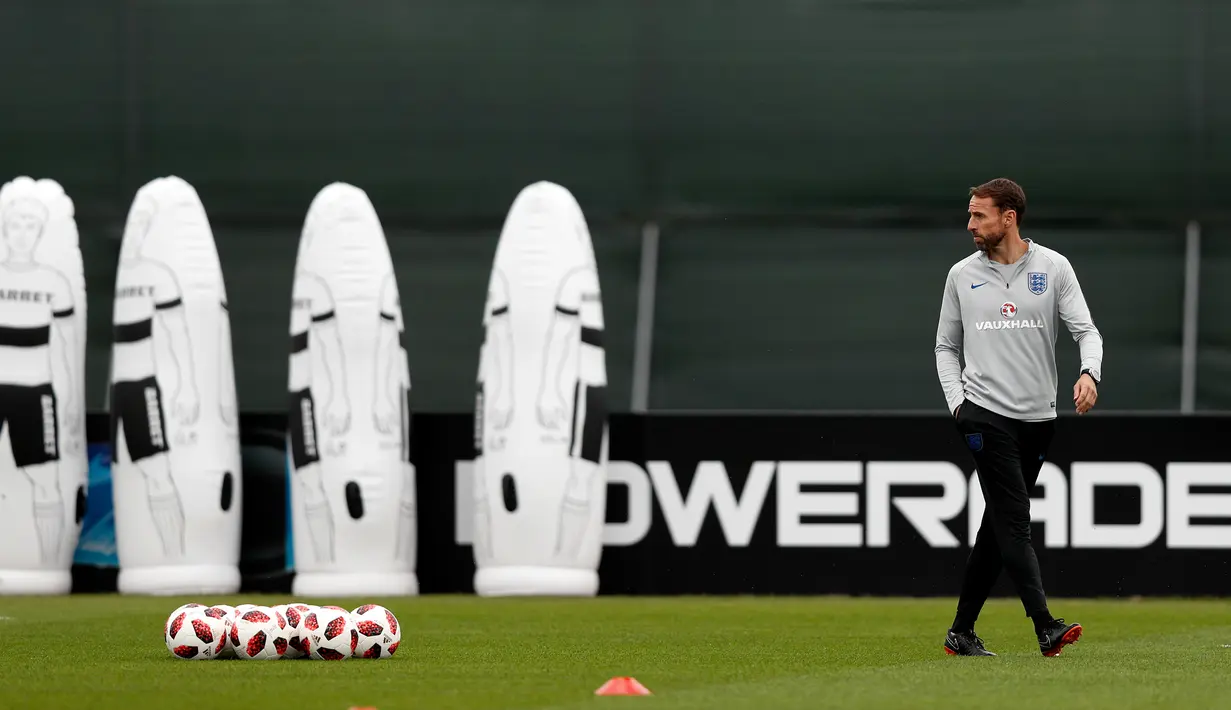 Pelatih Inggris, Gareth Southgate melihat para pemainnya berlatih jelang menghadapi Kroasia pada babak semifinal Piala Dunia 2018 di Repino (10/7). (AFP Photo/Adrian Dennis)