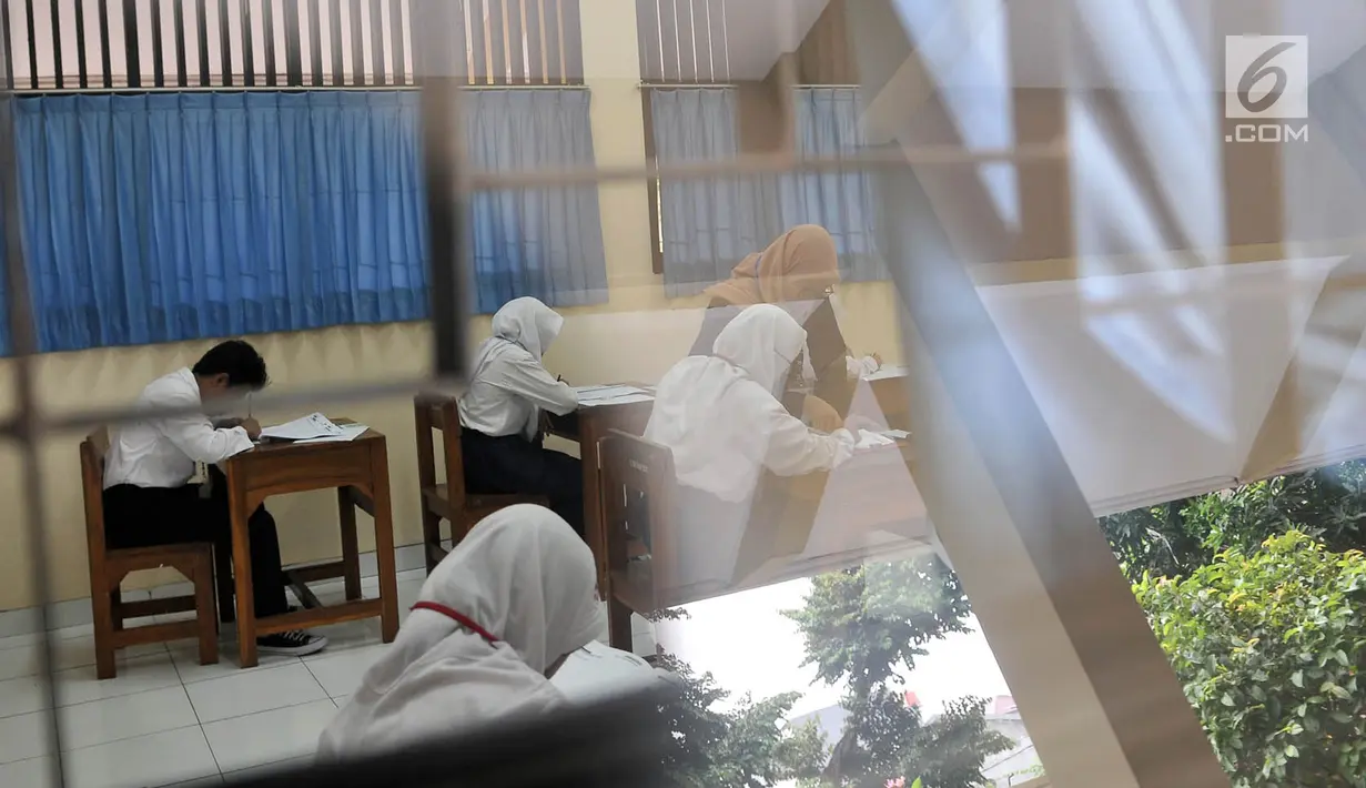 Suasana saat siswa SMPLB Kategori B atau tunarungu mengerjakan Ujian Nasional Kertas Pensil (UNKP) di SLB Negeri 7 Jakarta, Selasa (24/4). Ujian juga diikuti dua siswa dari SLB Bina Karya Insani dan satu dari SLB Karya Guna. (Merdeka.com/Iqbal Nugroho)