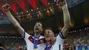 Per Mertesacker (kiri) berangkulan dengan Bastian Schweinsteiger merayakan kemenangan Jerman di Piala Dunia 2014 sekaligus mencetak sejarah sebagai tim Eropa pertama yang menang di Amerika Latin, (14/7/2014). (REUTERS/Eddie Keogh)