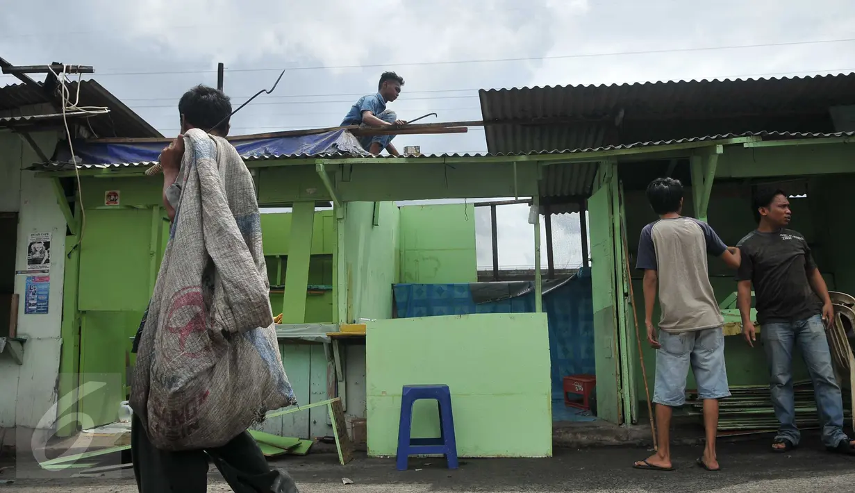 Sejumlah warga membongkar bangunan salah satu kafe di Kalijodo, Jakarta, Kamis (25/2). Pemerintah DKI melayangkan surat peringatan kedua (SP2) kepada warga untuk mengosongkan/membongkar sendiri bangunan mereka. (Lputan6.com/Gempur M Surya)