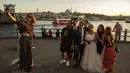 Wisatawan dari Iran berswafoto di Jembatan Galata di atas Tanduk Emas di Istanbul (26/7/2019). Sampai 1980-an Tanduk Emas merupakan tanah tempat pembuangan limbah industri, tetapi sejak setelah dibersihkan merupakan daya tarik wisata yang terkenal di Istanbul. (AP Photo/Emrah Gurel)