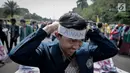 Seorang mahasiswa memakai ikat kepala saat aksi longmarch menuju Istana Merdeka, Jakarta, Senin (22/5). BEM SI menuntut kembalikan subsidi listrik 900VA dan BBM. (Liputan6.com/Faizal Fanani)