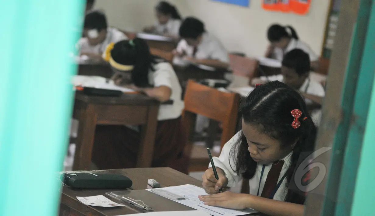 Seorang siswi mengerjakan soal Ujian Nasional (UN) mata pelajaran Bahasa Indonesia di SDN 04 Jakarta, Senin (18/5/2015). Sebanyak 153.266 peserta didik SD/MI dan sederajat di Jakarta mengikuti UN yang digelar 18-20 Mei. (Liputan6.com/Herman Zakharia)