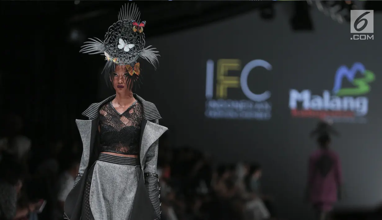 Model menampilkan baju rancangan Agus Sunandar pada ajang Jakarta Fashion Week 2018 di Senayan City, Jakarta, Selasa (24/10). Sebanyak 16 busana itu didominasi warna abu-abu dan hitam yang merupakan simbol dari batu karang. (Liputan6.com/Faizal fanani)