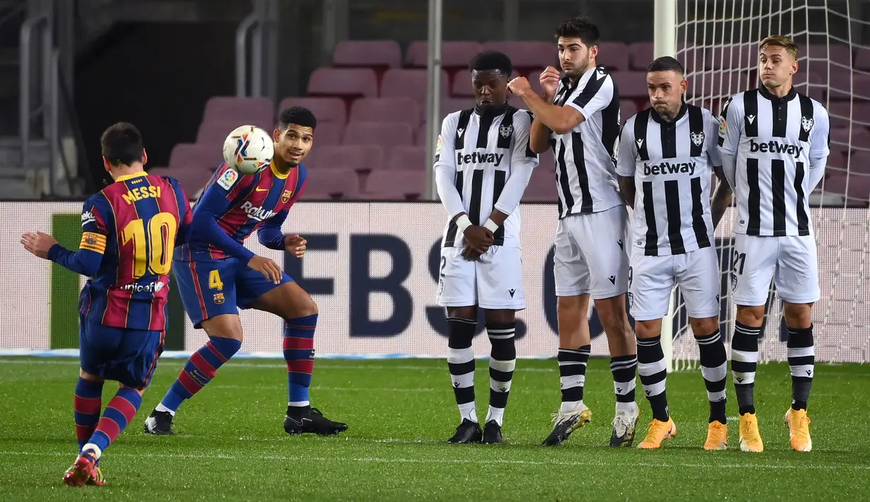 Striker Barcelona, Lionel Messi, melepaskan tendangan bebas saat melawan Levante pada laga Liga Spanyol di Stadion Camp Nou, Senin (14/12/2020). Barcelona menang dengan skor 1-0. (AFP/Lluis Gene)