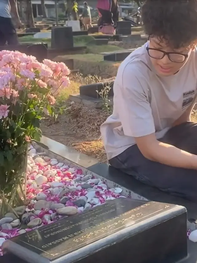 Angelina Sondakh dan anaknya di makam Adjie Massaid (Instagram/angelinasondakh09)
