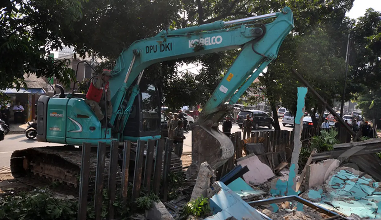 Petugas gabungan menggunakan alat berat merubuhkan beberapa bangunan liar di dekat stasiun Lenteng Agung, Jakarta, Rabu (28/1/2015). (Liputan6.com/Miftahul Hayat)