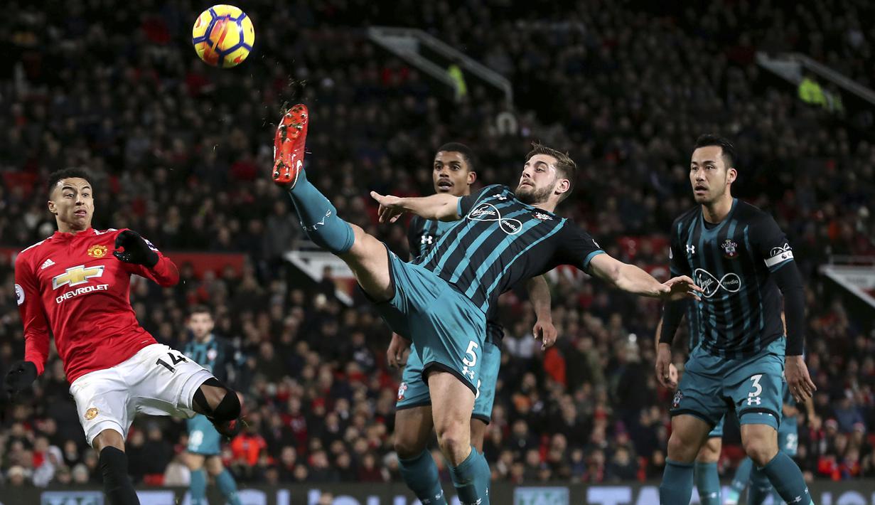 Pemain Manchester United, Jesse Lingard (kiri) mencoba mengganggu pemain Southampton, Jack Stephens yang membuang bola pada lanjutan Premier League di Old Trafford, Manchester, (30/12/2017). MU hanya bermain imbang 0-0.  (Martin Rickett/PA via AP)