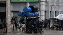 Sementara, ada lebih dari 170.000 orang terluka di Jalur Gaza sejak perang dimulai pada 7 Oktober 2023. Tampak dalam foto, seorang pria menunggang kereta kuda melewati banjir di kamp darurat yang menampung warga Palestina yang terlantar setelah hujan deras di Kota Gaza pada Selasa 25 November 2025. (Omar AL-QATTAA/AFP)