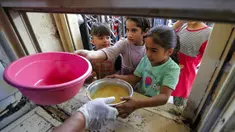 Anak-anak yang membutuhkan menerima makanan berbuka puasa dari juru masak di dapur Masjid Muslim Sunni Abdel Kader al-Kilani, Baghdad, Irak, 19 April 2021. Kegiatan ini berlangsung selama bulan suci Ramadhan. (AHMAD AL-RUBAYE/AFP)
