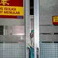 Petugas medis melihat keluar dari ruang isolasi untuk tempat pasien yang menunjukkan gejala wabah virus corona di sebuah rumah sakit umum di Mataram, Nusa Tenggara Barat (28/1/2020). (AFP/Moh El Sasaky)