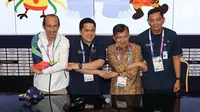 Ketua INASGOC, Erick Thohir (kedua kiri), dan Wakil Presiden, Jusuf Kalla (kedua kanan) bergandengan tangan usai meninjau Main Press Center (MPC) atau Media Center Asian Games di JCC, Jakarta, Selasa (14/8). (Liputan6.com/Fery Pradolo)