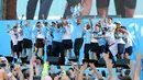 Pemain Manchester City mengangkat trofi Liga Primer Inggris selama melakukan parade merayakan keberhasilan menjadi juara Liga Primer Inggris di Manchester, Senin (14/5). Manchester City menjuarai Liga Inggris ke-18 kalinya.  (Richard Sellers/PA via AP)
