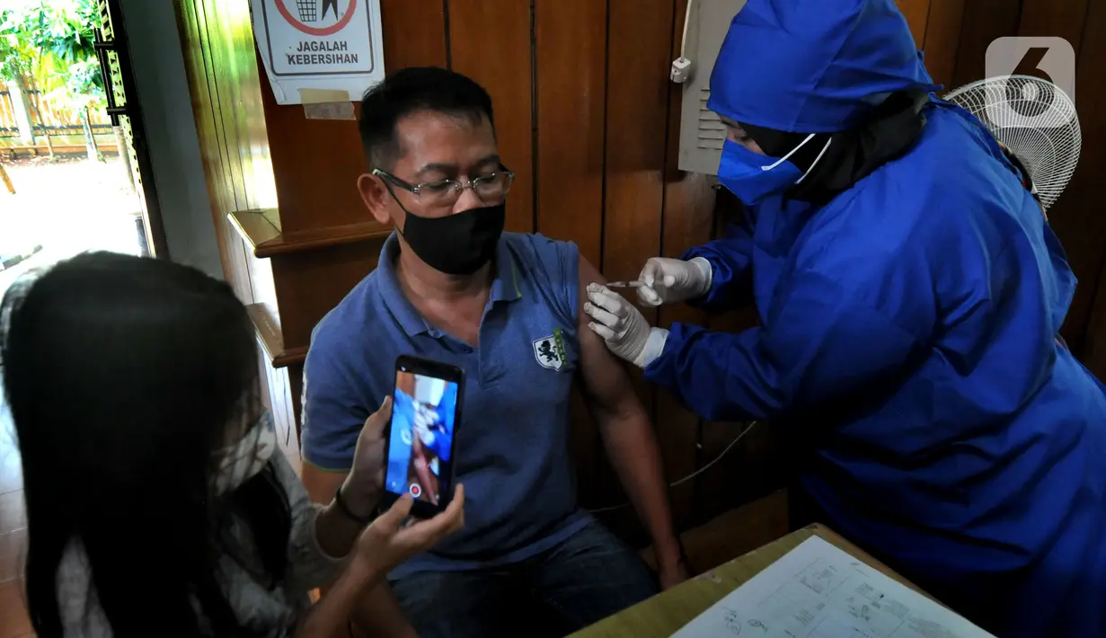 Paramedis menyuntikkan vaksin AstraZeneca kepada warga di Setu Babakan, Jagakarsa, Jakarta Selatan, Senin (14/06/2021). Hari ini lebih dari 400 warga seputar Setu Babakan divaksin oleh Dinkes Jakarta Selatan dalam rangka  rangka percepatan vaksinasi Covid-19. (merdeka.com/Arie Basuki)