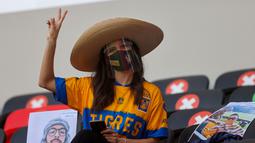 Fans cantik dari klub sepak bola asal Meksiko, Tigres mengacungkan lambang damai dalam pertandingan Piala Dunia Antar Klub 2020. (Foto: AFP/Karim Jaafar)