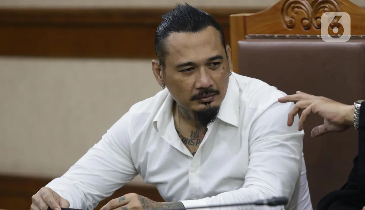 Musisi I Gede Ari Astina alias Jerinx SID sesaat sebelum sidang pembacaan putusan kasus dugaan pengancaman terhadap Adam Deni di PN Jakarta Pusat, Kamis (24/2/2022). I Gede Ari Astina divonis satu tahun penjara, denda Rp 25 juta subsider satu bulan kurungan. (Liputan6.com/Helmi Fithriansyah)