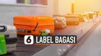 Label bagasi berfungsi amankan tas atau koper untuk bisa kembali kepada pemiliknya saat keluar dari pesawat.