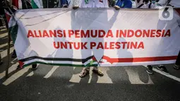 Massa membentangkan spanduk Aliansi Pemuda Indonesia untuk Palestina saat melakukan aksi solidaritas di depan Kedutaan Besar Amerika Serikat, Jakarta, Selasa (18/5/2021). Massa meminta pemerintah Indonesia mampu berkampanye dukung Palestina di
depan PBB. (Liputan6.com/Faizal Fanani)