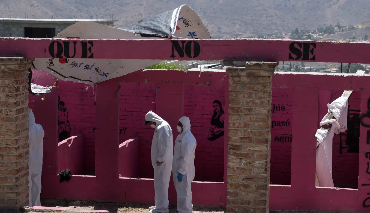 Tim forensik memeriksa sebuah kuburan massal yang ditemukan di Tijuana timur, Meksiko (17/8). Menurut pejabat setempat, lebih dari 600 fragmen tulang manusia ditemukan di perbatasan Meksiko-AS. (AFP Photo/Guillermo Arias)