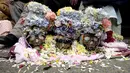 Tengkorak dihias dengan bunga - bunga selama upacara Dia de las natitas atau hari tengkorak di pemakaman Umum La Paz, Bolivia, Minggu (8/11/2015).  Mereka menyimpan tengkorak kerabat sendiri untuk dijadikan jimat keberuntungan. (REUTERS/David Mercado)