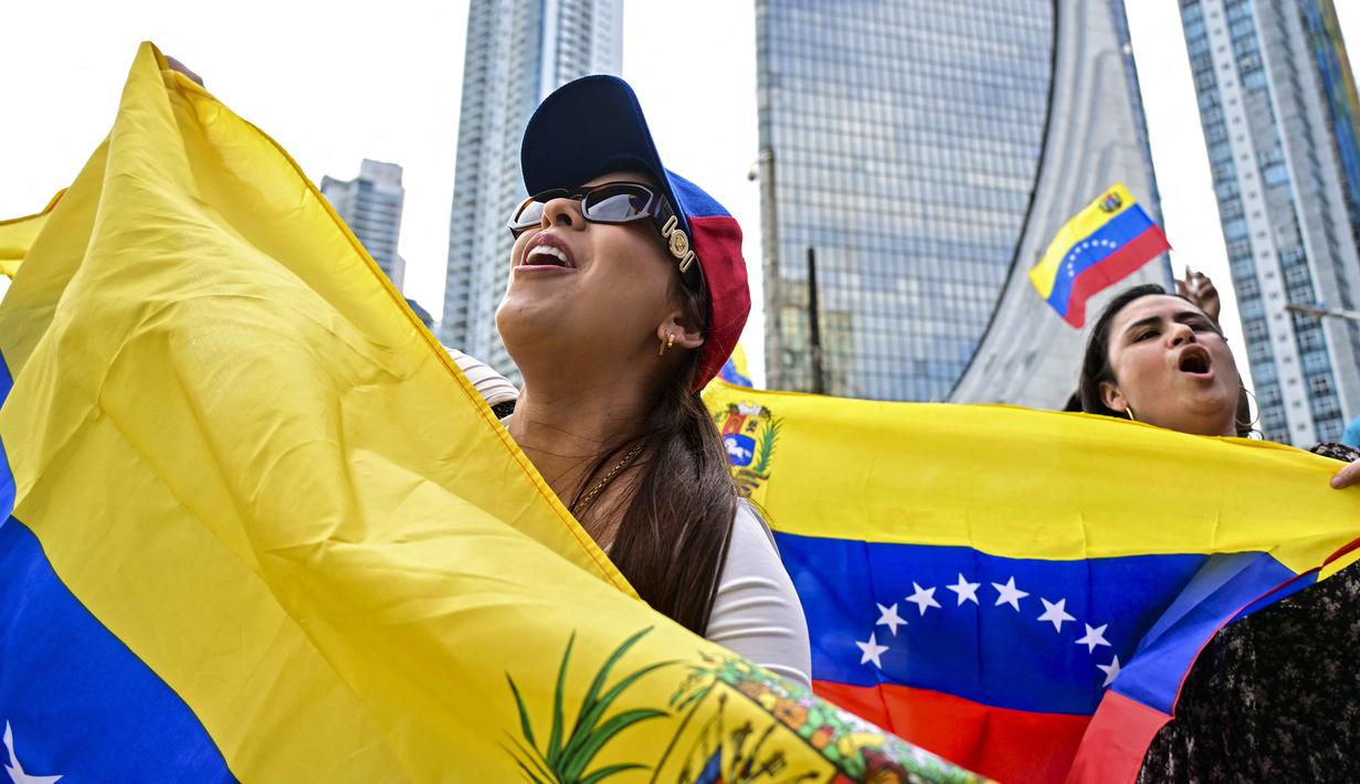 Sementara lebih dari 500.000 orang menuju ke arah selatan dengan tujuan akhir Ekuador, Peru, dan negara-negara lain di sekitarnya.  Tampak dalam foto, warga Venezuela yang tinggal di Panama merayakan penangkapan pemimpin mereka, Nicolas Maduro, dengan mengibarkan bendera di Kota Panama pada 3 Januari 2026. (MARTIN BERNETTI/AFP)