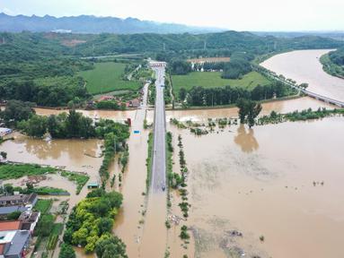 Foto udara menunjukkan banjir akibat hujan lebat di desa Xinanzhuang di distrik Miyun, pinggiran Beijing pada 29 Juli 2025. (ADEK BERRY/AFP)