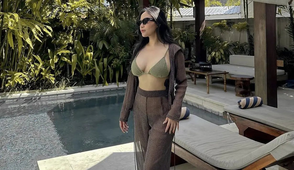 Rachel pun tampil seksi dengan bra top hijau dipadukan cardigan dan celana panjang coklat tipis.  (@rachelvennya)