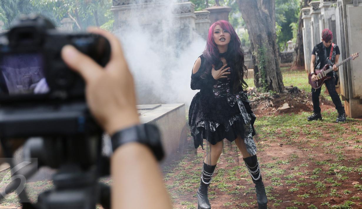 Gaya Dara dan Mita saat pembuatan video klip di Museum Taman Prasasti, Jakarta, Sabtu (23/1/2016). Nuansa gothic begitu kental di video klip 'Bungkam' ini. (Liputan6.com/Herman Zakharia)