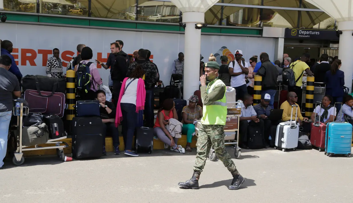 Penumpang yang terdampar menunggu penerbangan mereka di bandara JKIA, Nairobi, Rabu (6/3). Ratusan penumpang udara terdampar di Kenya setelah pemogokan oleh Serikat Pekerja Penerbangan Kenya di bandara utama Nairobi. (AP Photo/Khalil Senosi)