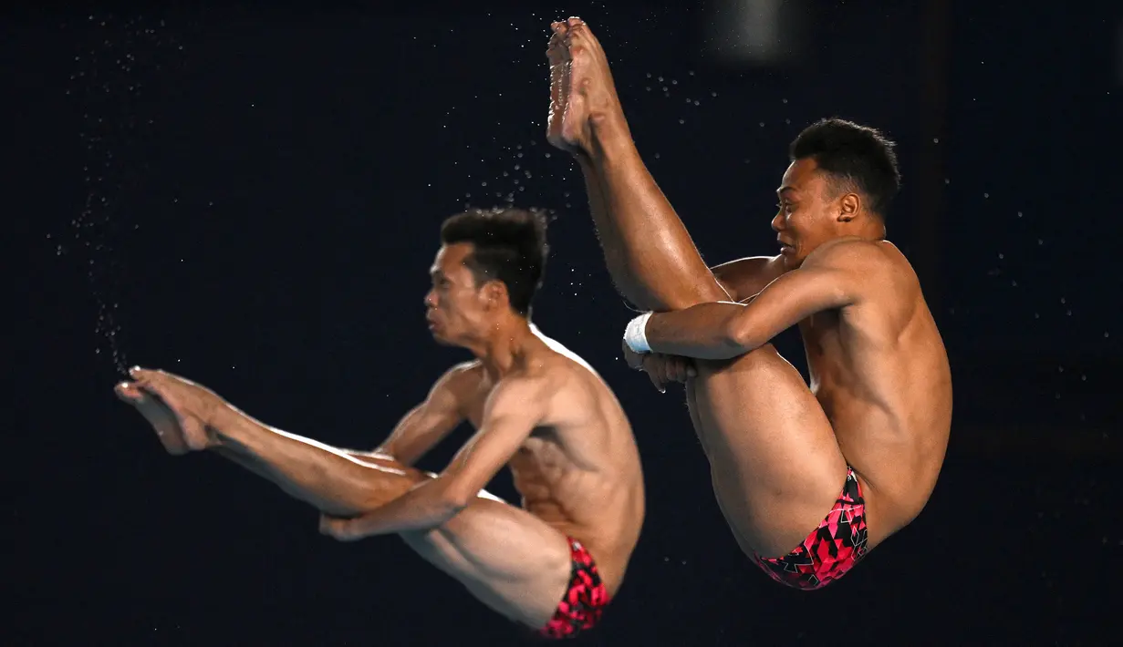 Andriyan Andriyan dan Adityo Restu Putra bertanding di final loncat indah sinkronisasi platform 10m putra pada Kejuaraan Akuatik Dunia 2024 di Hamad Aquatics Center, Doha, Qatar, 8 Februari 2024. (AFP/Oli Scarff)