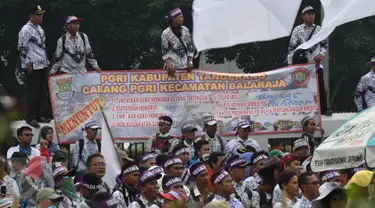 Ribuan guru honorer dari PGRI membentangkan spanduk saat menggelar aksi mogok dan unjuk rasa di depan gedung DPR/MPR, Jakarta, Selasa (15/9). Para guru honorer itu menuntut Pemerintah mengangkat mereka menjadi PNS. (Liputan6.com/Johan Tallo)