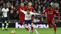 Gelandang Tottenham, Harry Winks, berusaha melewati gelandang Liverpool, Georginio Wijnaldum, pada laga Premier League di Stadion Tottenham, London, Sabtu (11/1). Tottenham kalah 0-1 dari Liverpool. (AFP/Glyn Kirk)