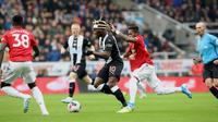 Pemain Newcastle United, Allan Saint-Maximin berebut bola dengan gelandang Manchester United, Fred pada laga pekan kedelapan Premier League, di St James' Park, Minggu (6/10/2019). Manchester United (MU) menelan kekalahan 0-1 dari Newcastle United. (Owen Humphreys/PA via AP)