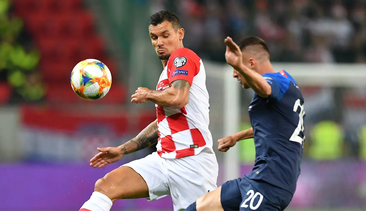 Bek Kroasia, Dejan Lovren, berebut bola dengan gelandang Slowakia, Robert Mak, pada laga Kualifikasi Piala Eropa 2020 di Trnava, Jumat (6/9). Slowakia kalah 0-4 dari Kroasia. (AFP/Joe Klamar)