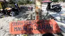 Sebuah papan dengan pesan Sudah Sengsara Masih Dijarah dipasang pasca gempa bumi dan tsunami di pinggir Jalan Trans Sulawesi, Palu, Sulawesi Tengah, Kamis (4/10). (Liputan6.com/Fery Pradolo)