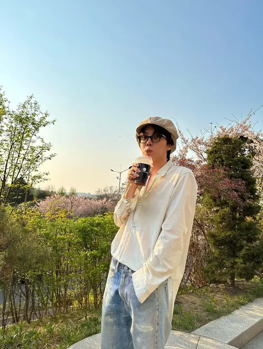 J-Hope BTS memilih untuk bawa bekal saat melihat bunga bermekaran. Apakah yang diseruputnya ini adalah ice americano kegemarannya? (Instagram/ uarmyhope)