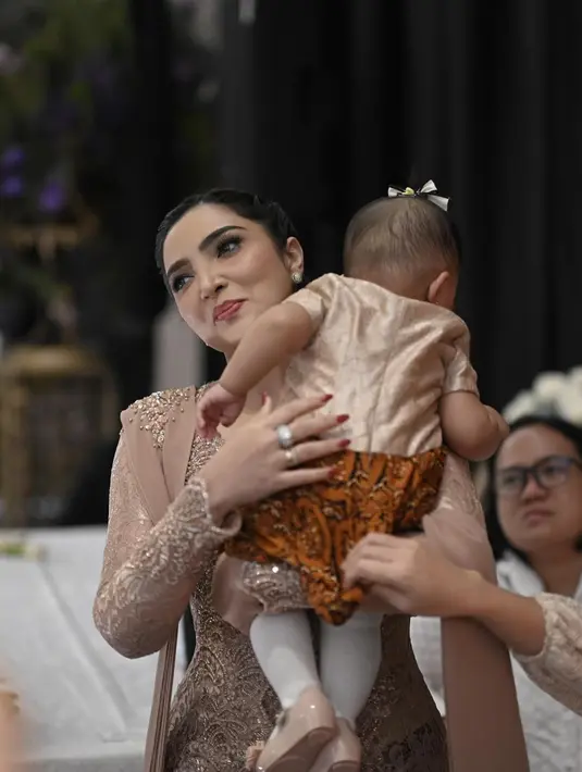 Ashanty tampil awet muda dengan gaya rambut yang ditata sleek look, dikepang lalu ditarik ke belakang dan dilow-bun. [Foto: Instagram/ashanty_ash]