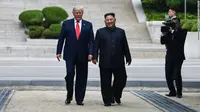 Presiden AS Donald Trump dan Pemimpin Korea Utara Kim Jong-un di sisi utara garis demarkasi militer, zona demiliterisasi Korea (DMZ), Panmunjom pada Minggu 30 Juni 2019 (Brendan Smialowski / AFP PHOTO)