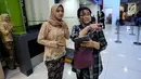 Petugas frontliner berpakaian tradisional membantu calon penumpang di Stasiun Gambir, Jakarta, Minggu (21/4). PT KAI Daop 1 Jakarta mewajibkan petugas frontliner wanita dan pria mengenakan kebaya dan batik untuk menyambut Hari Kartini. (Liputan6.com/Johan Tallo)